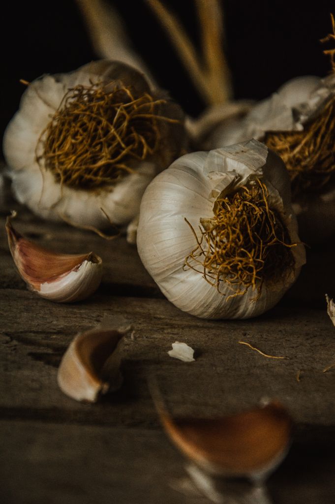 Garlic bulbs and cloves on a rustic wooden table